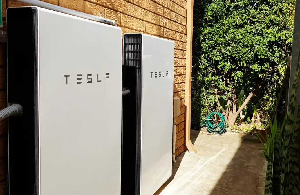 Two-Tesla-Powerwall-batteries-powering-a-home https://adelaidesolarsolutions.com.au/wp-content/uploads/2025/07/Two-Tesla-Powerwall-batteries-powering-a-home-e1751424846675.webp